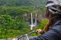 Woman riding bicycle at Banos, Ecuador