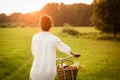 Woman riding bicycle with the basket of fresh food. Royalty Free Stock Photo
