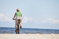 Woman riding bicycle in beach Royalty Free Stock Photo