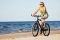 Woman riding bicycle in beach Royalty Free Stock Photo