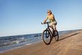 Woman riding bicycle in beach Royalty Free Stock Photo