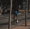 Woman riding bicycle through the city