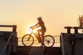 Woman riding bicycle, exercising in sunset town