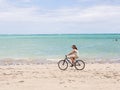 Woman riding bike at the beach Royalty Free Stock Photo