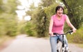 Woman riding bike excited on Royalty Free Stock Photo