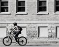 Woman Riding Bike by Old Building