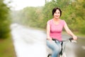 Woman riding bike on the rainy Royalty Free Stock Photo