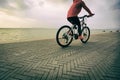 Woman riding bike on seaside Royalty Free Stock Photo
