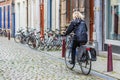 A woman riding bike on stone made city road