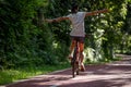 Woman riding a bike on sunny park trail Royalty Free Stock Photo