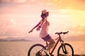 woman riding a bike on sunny seaside Royalty Free Stock Photo