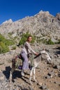Woman riding on donkey in the mountain