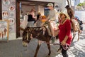 Woman riding donkey. Using donkey taxi to the Acropolis is a popular tourist attraction in Lindos