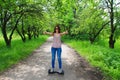 Woman riding an electrical scooter outdoors - hover board, smart balance wheel, gyro scooter, hyroscooter, personal Eco transport