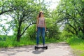 Woman riding an electrical scooter outdoors - hover board, smart balance wheel, gyro scooter, hyroscooter, personal Eco transport