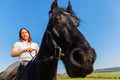 Woman riding a Friesian horse Royalty Free Stock Photo