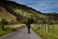 Woman riding her bike on the beautiful landscapes of the Cocora Valley in Colombia