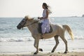 A woman riding horse on beach Royalty Free Stock Photo