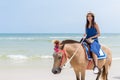 Woman riding horse in the sand beach Royalty Free Stock Photo