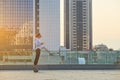 Woman riding hoverboard, side view.