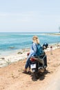 Woman riding motorcycle along the sea on the road to Hai Van pass, Vietnam