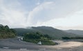 Woman riding motorcycle on winding roads of Hai Van pass from Hue city to Hoi An, Vietnam