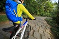 Woman riding mountain bike on forest trail Royalty Free Stock Photo