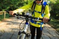 Woman riding mountain bike on forest trail Royalty Free Stock Photo