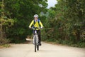 Woman riding mountain bike on forest trail Royalty Free Stock Photo