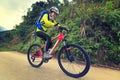 Woman riding mountain bike on forest trail Royalty Free Stock Photo