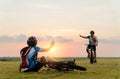 Woman riding mountain bike was accident crashed and fell to the grass while a lover her coming in to help at the beautiful sunset