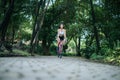 Woman riding a road bike. Portrait of young beautiful woman on pink bike Royalty Free Stock Photo