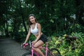 Woman riding a road bike. Portrait of young beautiful woman on pink bike Royalty Free Stock Photo