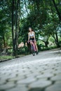 Woman riding a road bike. Portrait of young beautiful woman on pink bike Royalty Free Stock Photo