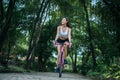 Woman riding a road bike. Portrait of young beautiful woman on pink bike Royalty Free Stock Photo