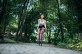 Woman riding a road bike. Portrait of young beautiful woman on pink bike Royalty Free Stock Photo