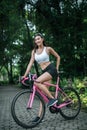 Woman riding a road bike. Portrait of young beautiful woman on pink bike Royalty Free Stock Photo