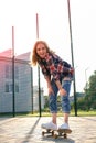 Woman riding a skateboard on street. Skater girl on a longboard. Cool female skateboarder at sunset. Carefree female Royalty Free Stock Photo