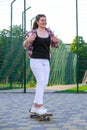 Woman riding a skateboard on street. Skater girl on a longboard. Cool female skateboarder at sunset. Carefree female Royalty Free Stock Photo