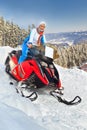 Woman riding a snowmobile Royalty Free Stock Photo