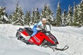 Woman riding a snowmobile Royalty Free Stock Photo