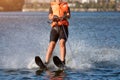 Woman riding water skis closeup. Body parts without a face. Athlete water skiing and having fun. Living a healthy