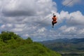 Woman riding in zip line in the Valley of Sugar Mills in Trinidad Cuba