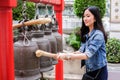 Woman ringing a bell in a Buddhist temple Royalty Free Stock Photo