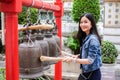Woman ringing a bell in a Buddhist temple Royalty Free Stock Photo