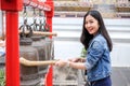 Woman ringing a bell in a Buddhist temple Royalty Free Stock Photo