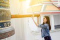 Woman ringing a bell in a Buddhist temple Royalty Free Stock Photo