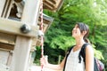 Woman ringing the bell in Japanese temple Royalty Free Stock Photo