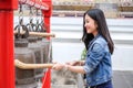 Woman ringing a bell in a temple in Thailand Royalty Free Stock Photo