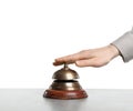 Woman ringing hotel service bell at stone table Royalty Free Stock Photo